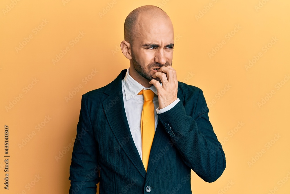 Young hispanic man wearing business suit and tie looking stressed and nervous with hands on mouth biting nails. anxiety problem. Young hispanic man wearing business suit and tie looking stressed and nervous with hands on mouth biting nails. anxiety problem.
