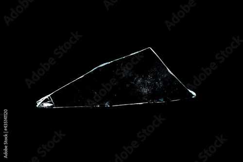 glass fragments in isolation on a black background. damaged window. damaged object