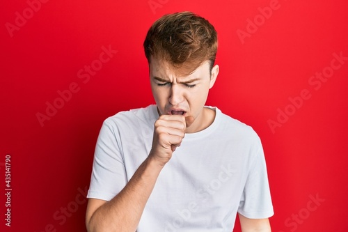 Young caucasian man wearing casual white t shirt feeling unwell and coughing as symptom for cold or bronchitis. health care concept.