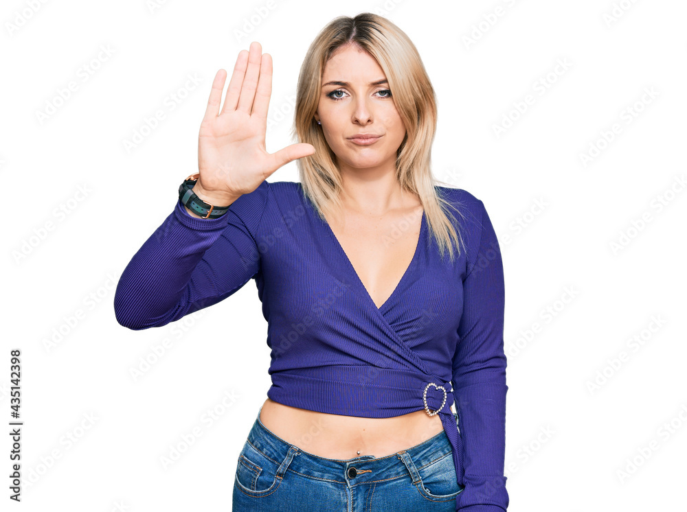 Young caucasian woman wearing casual clothes doing stop sing with palm of the hand. warning expression with negative and serious gesture on the face. Young caucasian woman wearing casual clothes doing stop sing with palm of the hand. warning expression with negative and serious gesture on the face.