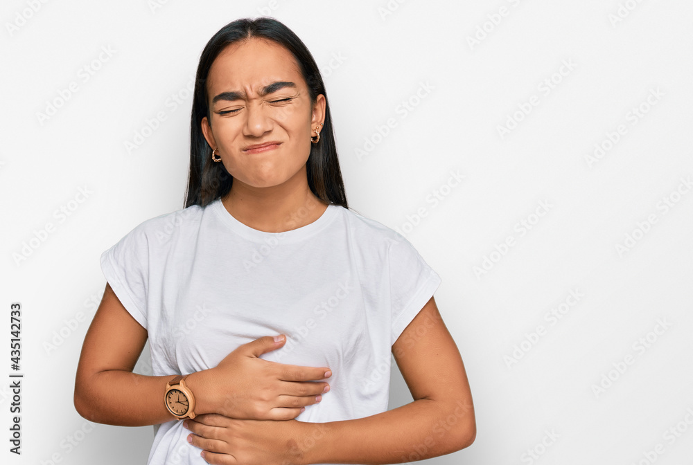 Obraz premium Young asian woman wearing casual white t shirt with hand on stomach because indigestion, painful illness feeling unwell. ache concept.