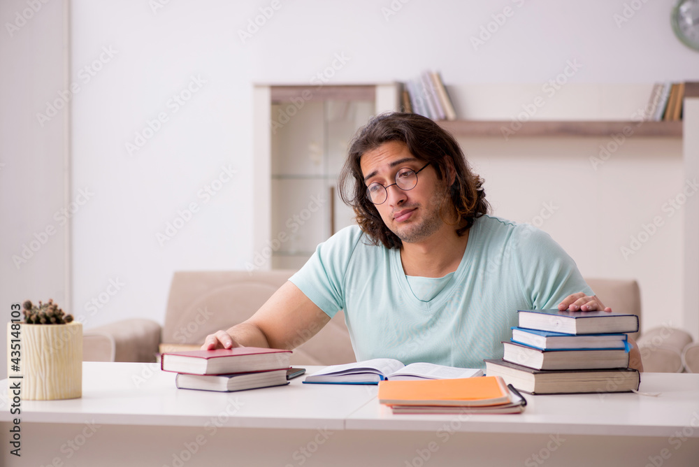 Young male student preparing for exams at home Young male student preparing for exams at home
