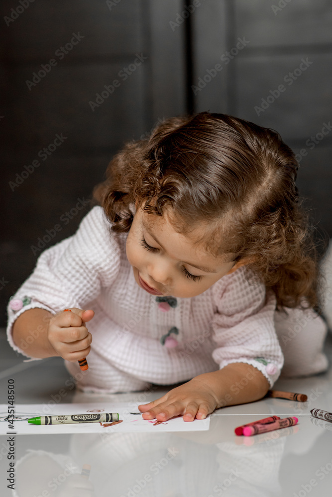 Girl in pajamas drawing and smiling coloring and painting