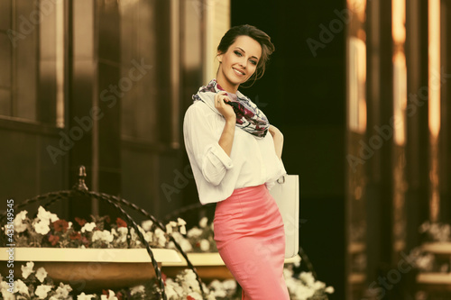 Young fashion business woman in white shirt and pencil skirt at office building