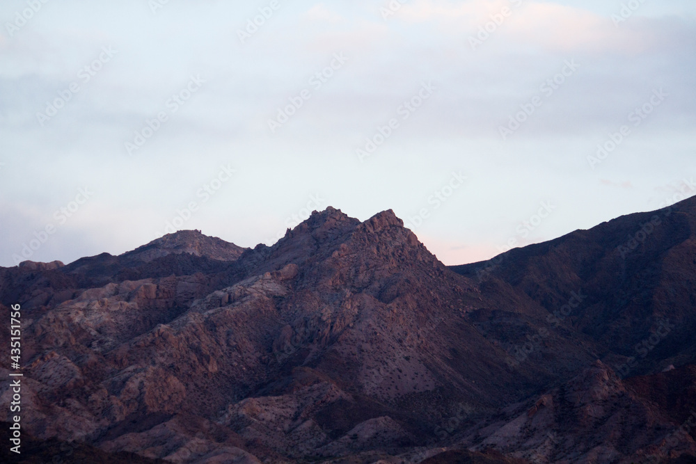 Naklejka premium The Andes mountain range at sunset. Beautiful purple hills rocky texture background. 