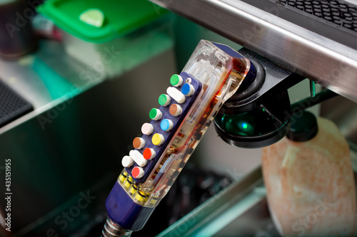 Valokuva A view of a soda fountain dispenser gun, in a bar or restaurant setting