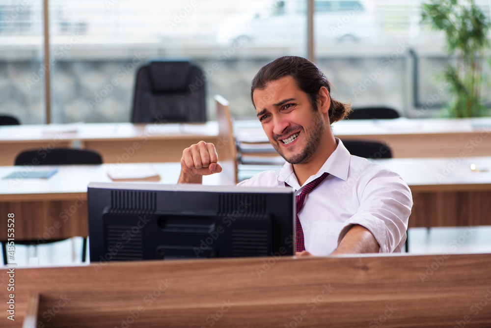 Young male employee and too many work in the office Young male employee and too many work in the office