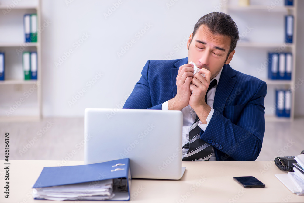 Sick male employee suffering at workplace Sick male employee suffering at workplace