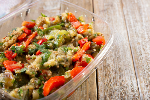 A view of a container of Armenian grilled vegetable salad, also known as khorovats salad.