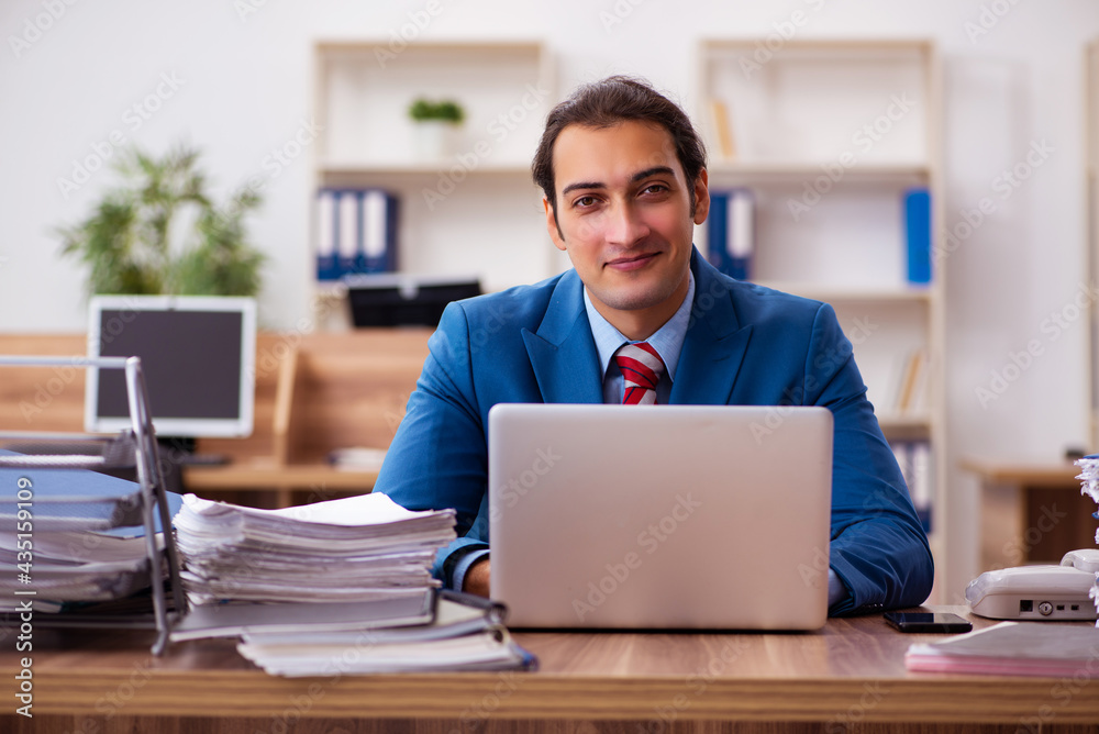 Young male employee working in the office Young male employee working in the office