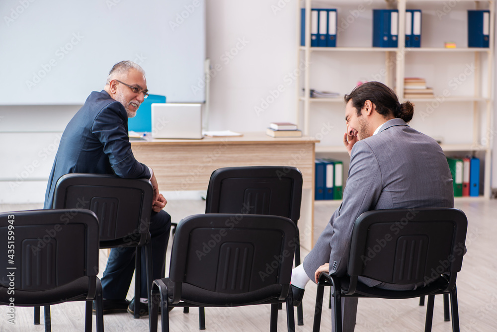 Two businessmen in the classroom in pandemic concept Two businessmen in the classroom in pandemic concept