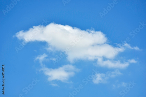 Beautiful cumulus clouds against the blue daytime sky.