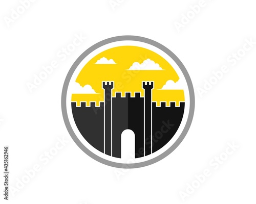Circle shape with fortress and sunset behind