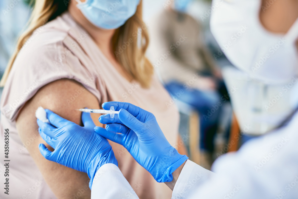 Close-up of female patient getting vaccinated against coronavirus. Close-up of female patient getting vaccinated against coronavirus.