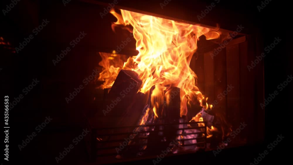 SLOW MOTION, CLOSE UP: Idyllic shot of logs burning inside a firepit in the living room on a cold night. Picturesque shot of a romantic fire burning inside a vintage fireplace in a dark luxury house. SLOW MOTION, CLOSE UP: Idyllic shot of logs burning inside a firepit in the living room on a cold night. Picturesque shot of a romantic fire burning inside a vintage fireplace in a dark luxury house.