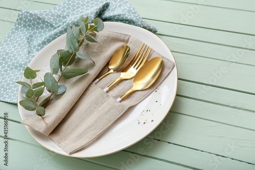Beautiful table setting on color wooden background