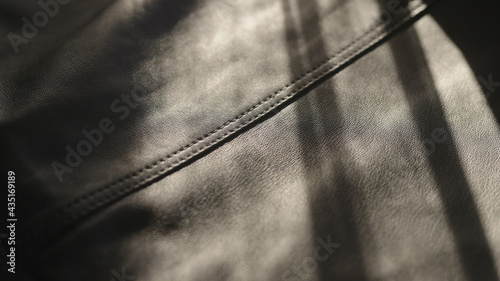 soft supple gray leather background with light streak from sun