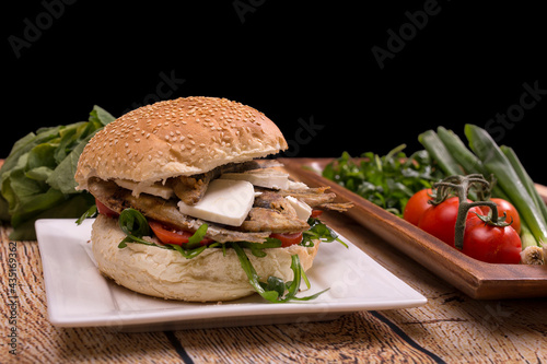 Burger with fried sardinas and feta cheese photo