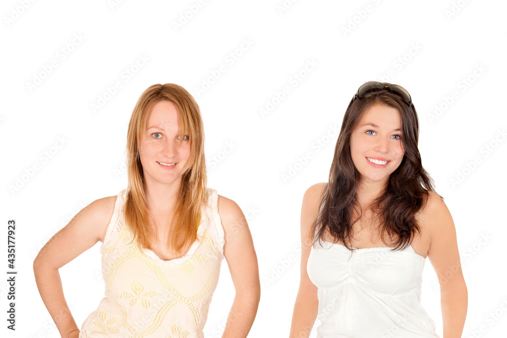 Closeup portraits of two happy young women wearing summer tops, isolated in front of white studio background