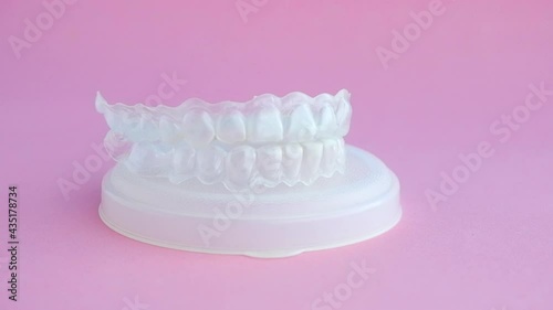 individual teeth whitening tray and bleaching gel syringe on white background