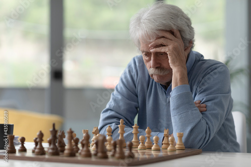 Focused senior man playing chess