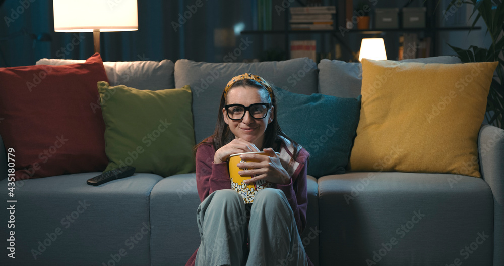 Obraz premium Cheerful woman watching her favorite series