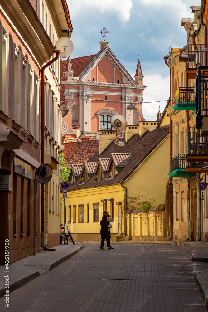 Old streets in European cities. Narrow streets between houses. Colorful architecture. Quiet streets and courtyards in Vilnius . Lithuania