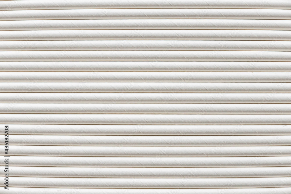 A row of biodegradable eco friendly white paper drinking straw as a background. A row of biodegradable eco friendly white paper drinking straw as a background.