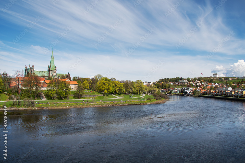 View of Nidarosdomen and Christiansten fortress, Trondheim, Norway.. The river Nidelva flows between them. The photo is shot from the bridge, Elgseter.