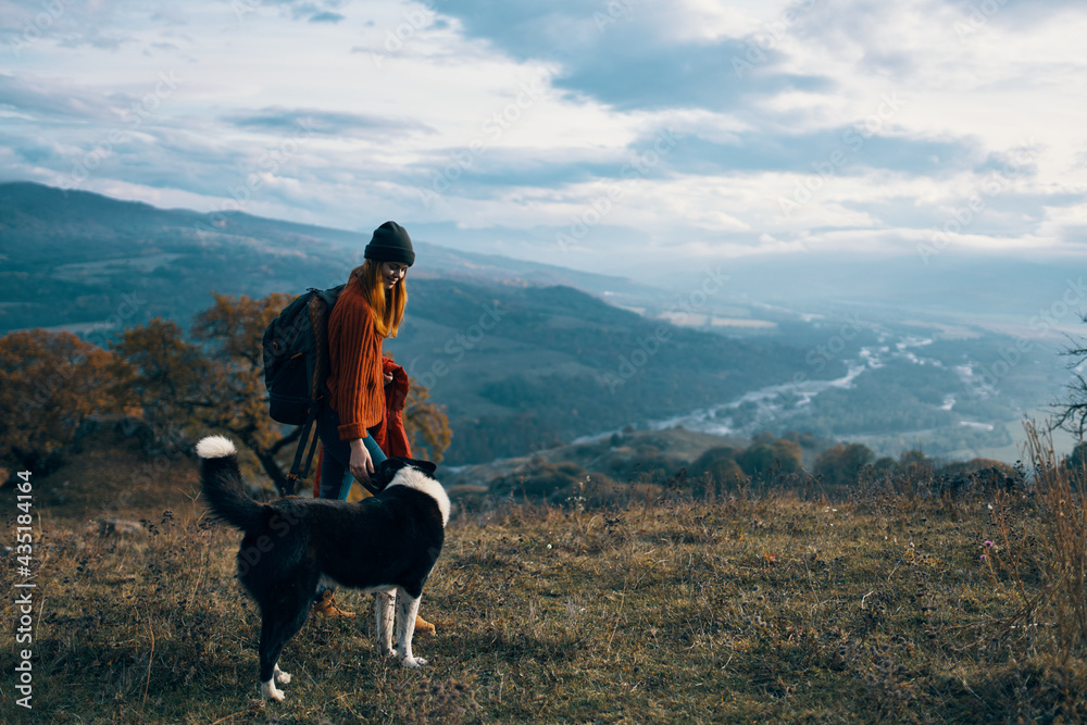 woman with backpack on nature next to dog walk mountain landscape woman with backpack on nature next to dog walk mountain landscape