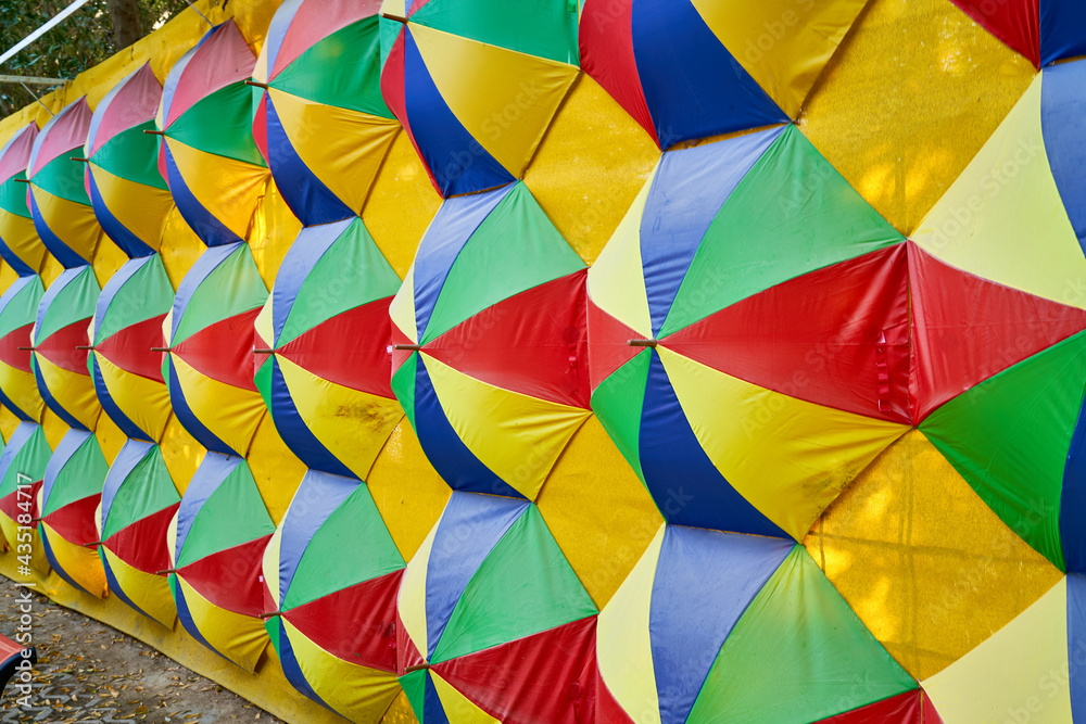 Fototapeta premium colored umbrellas hang on the wall