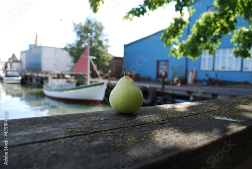 Pear in foreground fishing vessel in background  © Jimmy