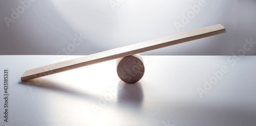 Balance concept, board on wooden top hat like balance isolated on the white background.
