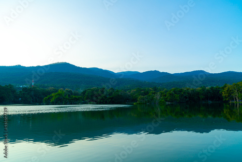 Ang Kaew lake at Chiang Mai University with forested mountain