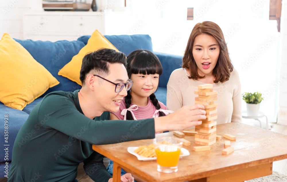 Happy Asian family having fun playing block game in the living room at home. Happy Asian family having fun playing block game in the living room at home.