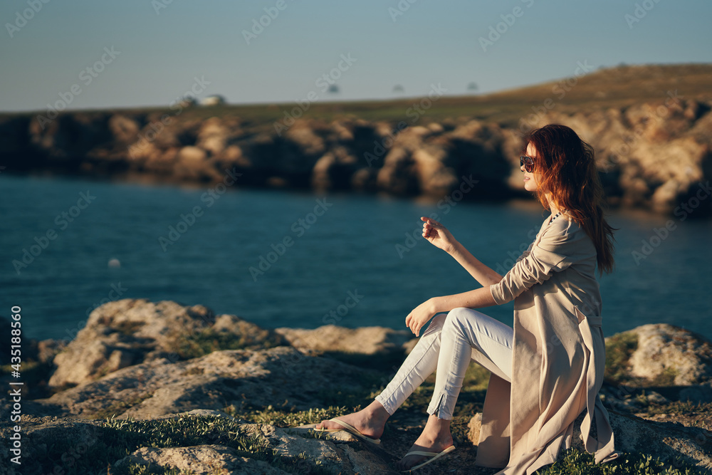 woman in summer on stones mountains outdoors and sweaters white pants model landscape