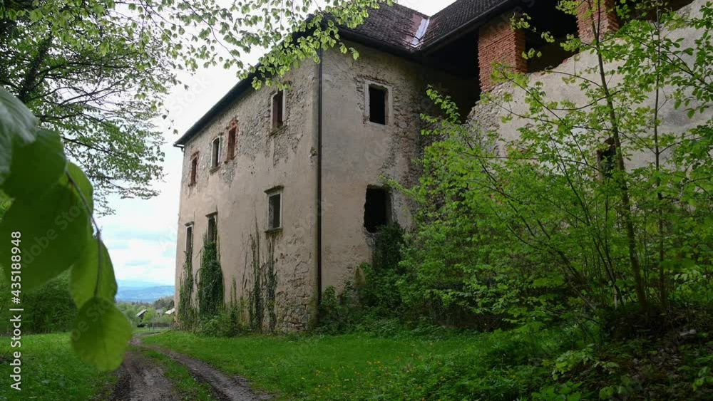 Old abandoned renaissance building in remote village. Historic mansion in Slovenia. Countryside ruined building. Spooky ruins in nature. Handheld, establishment shot Old abandoned renaissance building in remote village. Historic mansion in Slovenia. Countryside ruined building. Spooky ruins in nature. Handheld, establishment shot