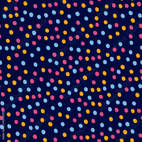 Seamless repeating spotted pattern with bright confetti-like hand drawn dots. Dark blue vector background for gift wrapping papaer, surface design and other design projects