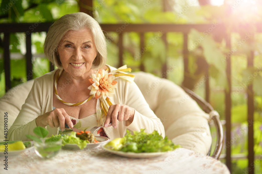 Portrait of happy senior woman eating delicious salad Portrait of happy senior woman eating delicious salad