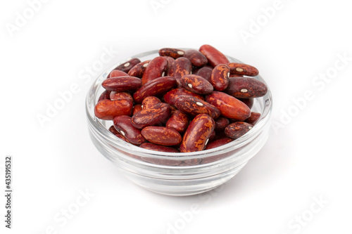 A pile of fresh raw red beans in a transparent bowl, isolated on a white background.