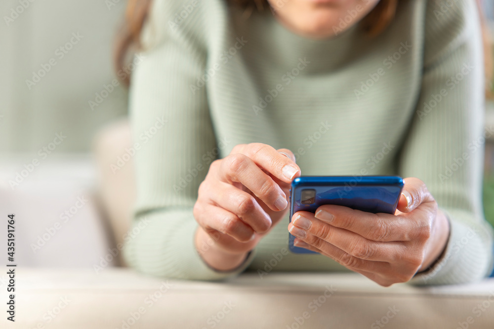 Women's hand typing on smartphone. Women's hand typing on smartphone.