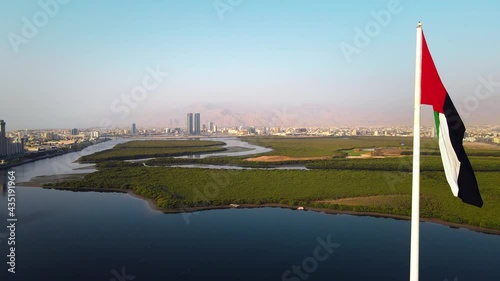 UAE flag and Ras al Khaimah emirate in the north United Arab Emirates aerial skyline landmark view