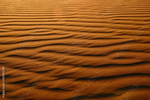 Horizontal pattern on a dune created by wind at sunset in the Namibian desert