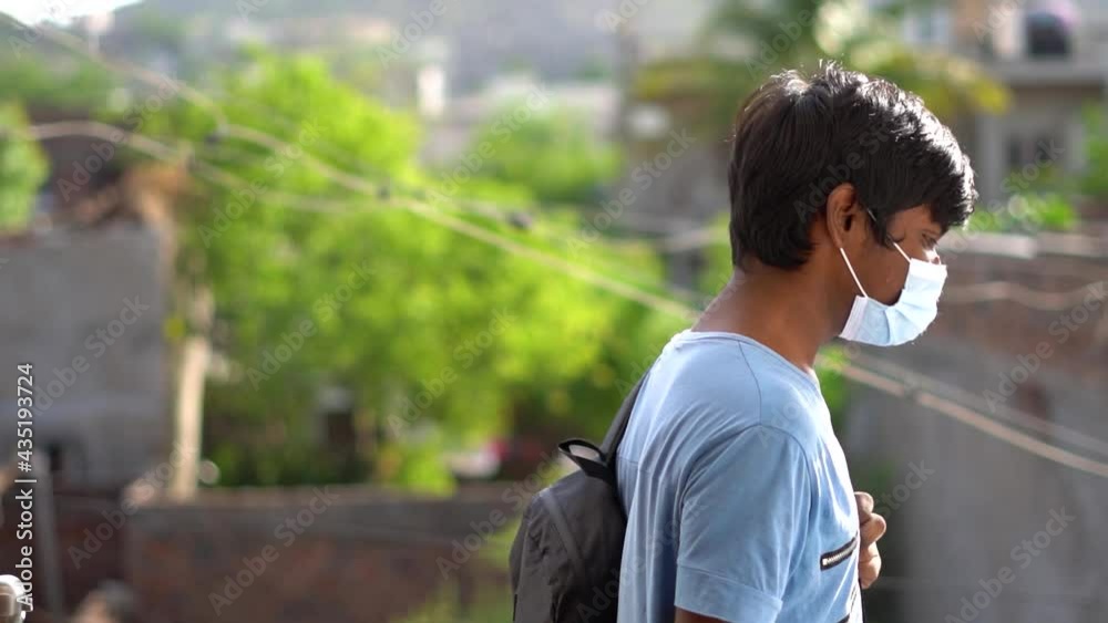 Portrait of an Indian kid wearing mask going to school, New normal in schools Portrait of an Indian kid wearing mask going to school, New normal in schools