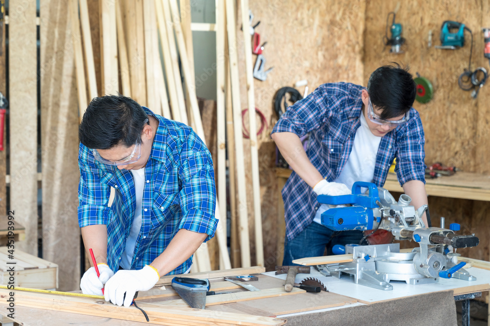 Worker or Professional constructor repair in wood working. Carpenter working with belt grinding machine. Worker or Professional constructor repair in wood working. Carpenter working with belt grinding machine.