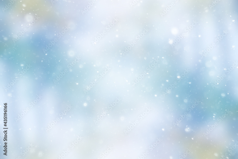 blurred snow / winter abstract background, snowflakes on abstract blurred glowing leaf background