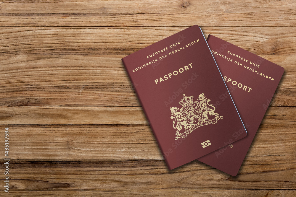 Netherlands passport on a wooden background, citizenship by investment, Dutch citizen Netherlands passport on a wooden background, citizenship by investment, Dutch citizen