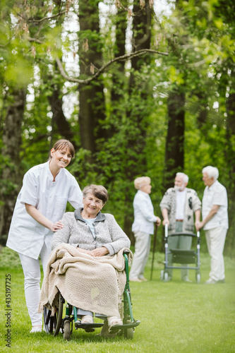 Elder and disabled people in the garden spending time together