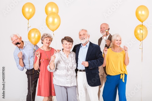 Group of happy senior people celebrating and having fun together