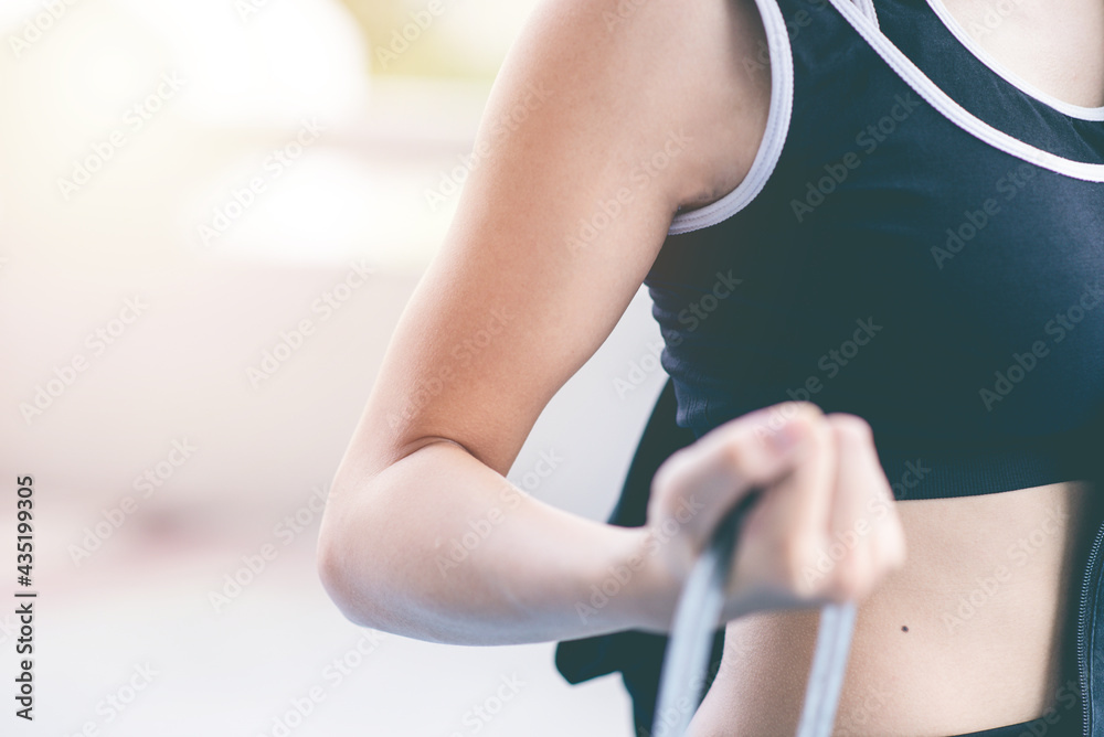 Fototapeta premium Close up hand of Athletic holding Skipping Rope or Jump rope. exercise, training, fitness, workout, sport, lifestyle and healthy concept. strength training concept.